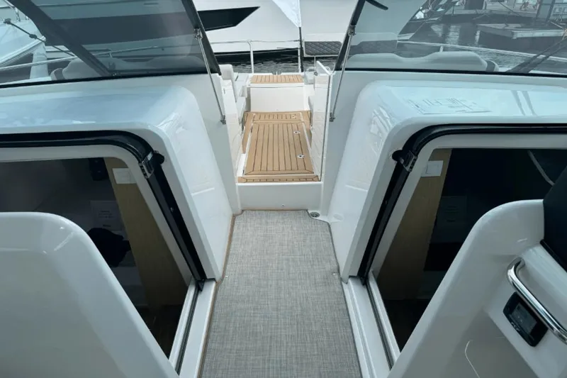 Slide: The Image of Interior view of 2024 Aquila 36 Sport yacht with teak flooring and open cabin doors. - 13