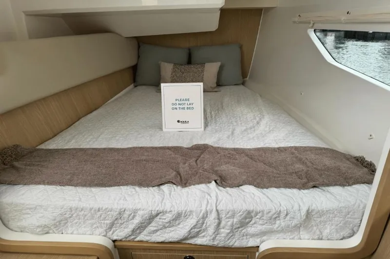 Slide: The Image of Interior cabin bed of 2024 Aquila 36 Sport with Do Not Lay sign. - 15