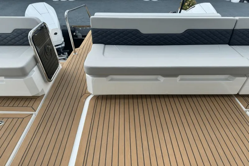 Slide: The Image of Aquila 36 Sport 2024 boat deck with cushioned seating and teak flooring. - 8