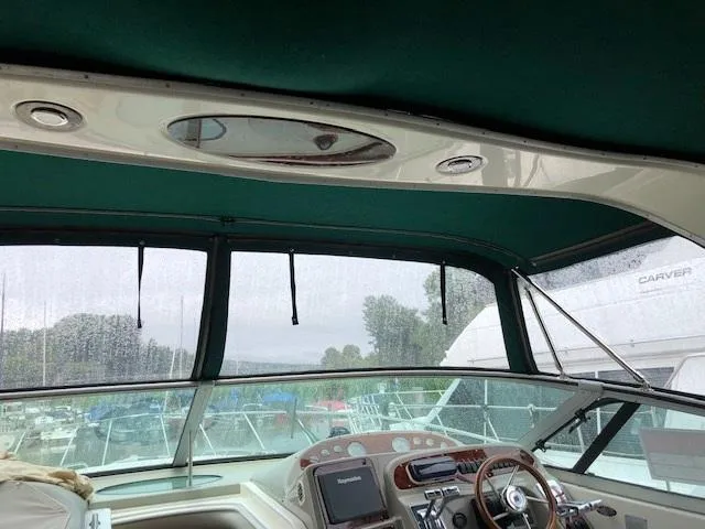 Slide: The Image of Interior view of 1998 Maxum 3700 SCR boat cockpit with green canopy. - 11