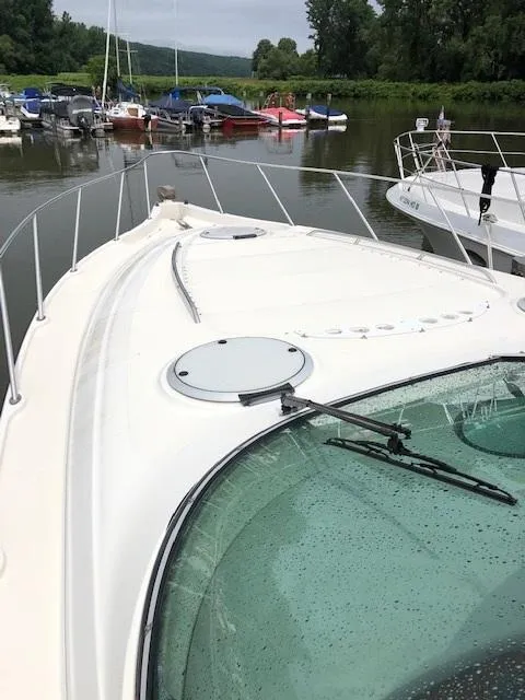 Slide: The Image of 1998 Maxum 3700 SCR yacht docked in a marina. - 12