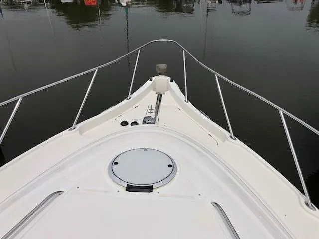 Slide: The Image of Bow of 1998 Maxum 3700 SCR yacht in a marina. - 13