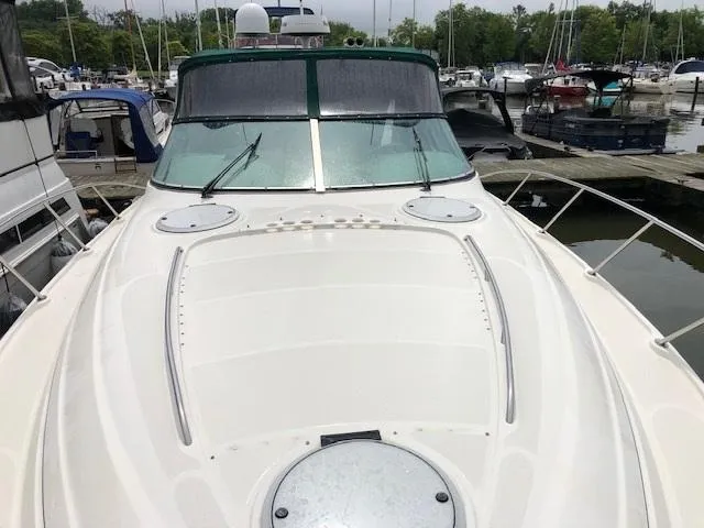 Slide: The Image of 1998 Maxum 3700 SCR yacht docked at a marina. - 15