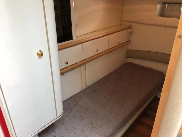 Slide: The Image of 1998 Maxum 3700 SCR cabin with single bed and storage cabinets. - 23