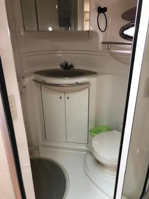 Slide: The Image of Compact bathroom in a 1998 Maxum 3700 SCR boat with sink and toilet. - 24