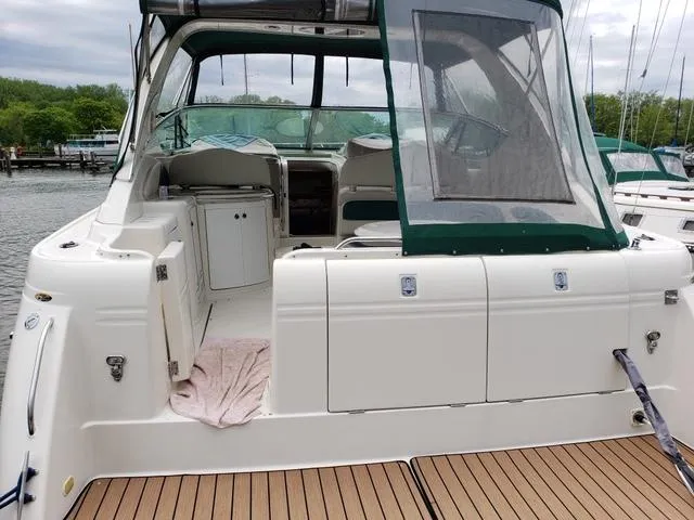 Slide: The Image of 1998 Maxum 3700 SCR yacht with green canopy docked at marina. - 4
