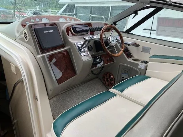 Slide: The Image of 1998 Maxum 3700 SCR boat interior with steering wheel and control panel. - 8