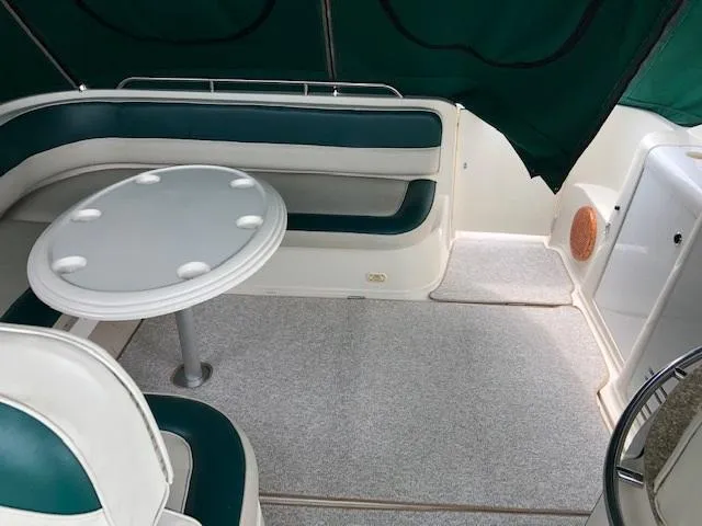 Slide: The Image of 1998 Maxum 3700 SCR boat interior with seating and table. - 9