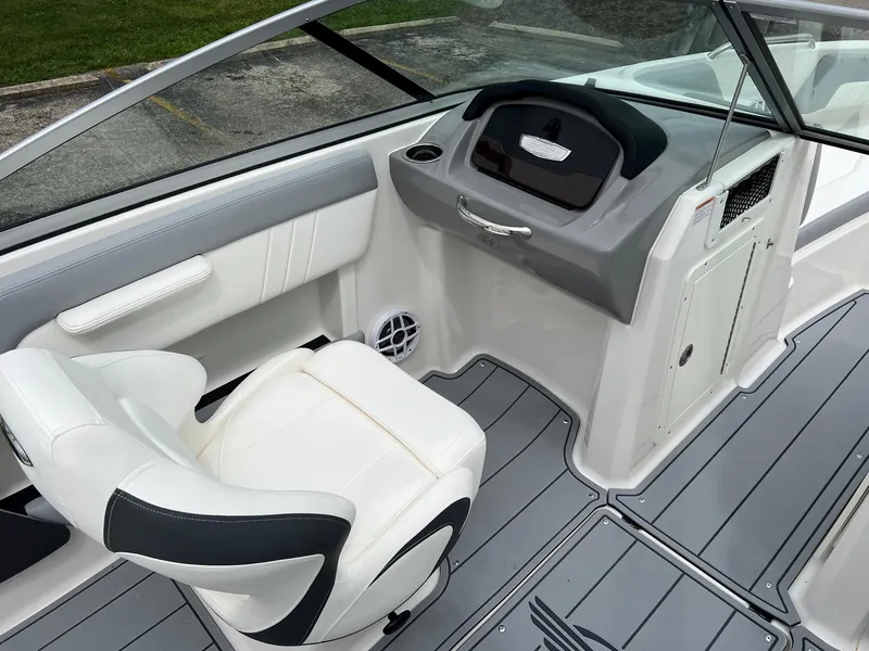 Slide: The Image of 2024 Chaparral 21 SSi boat interior with white seating and sleek dashboard design. - 3