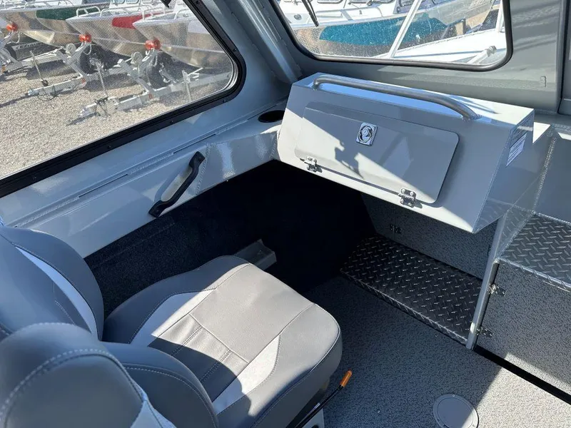 Slide: The Image of 2024 Hewescraft 220 Ocean Pro HT ET interior, featuring passenger seat and storage compartment. - 7