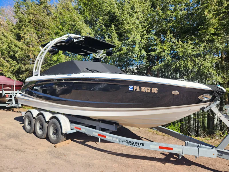 Slide: The Image of 2011 Cobalt A25 boat on Load Rite trailer, parked outdoors. - 0