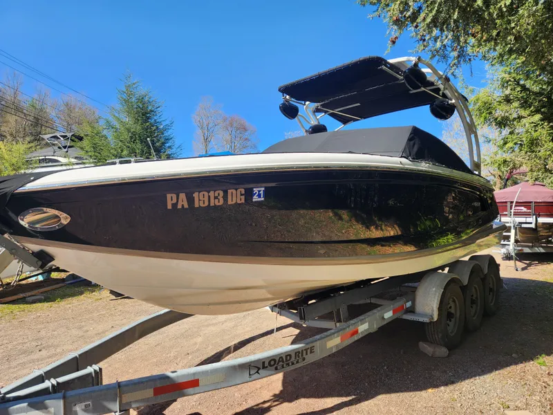Slide: The Image of 2011 Cobalt A25 boat on Load Rite trailer in outdoor setting. - 1