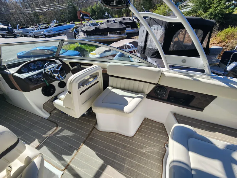 Slide: The Image of 2011 Cobalt A25 boat interior with luxurious seating and modern dashboard. - 12