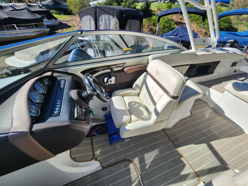 Slide: The Image of 2011 Cobalt A25 boat interior with steering wheel and seating. - 13