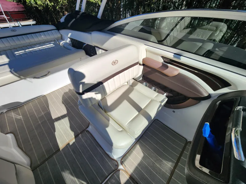 Slide: The Image of 2011 Cobalt A25 boat interior with white leather seats and gray flooring. - 14