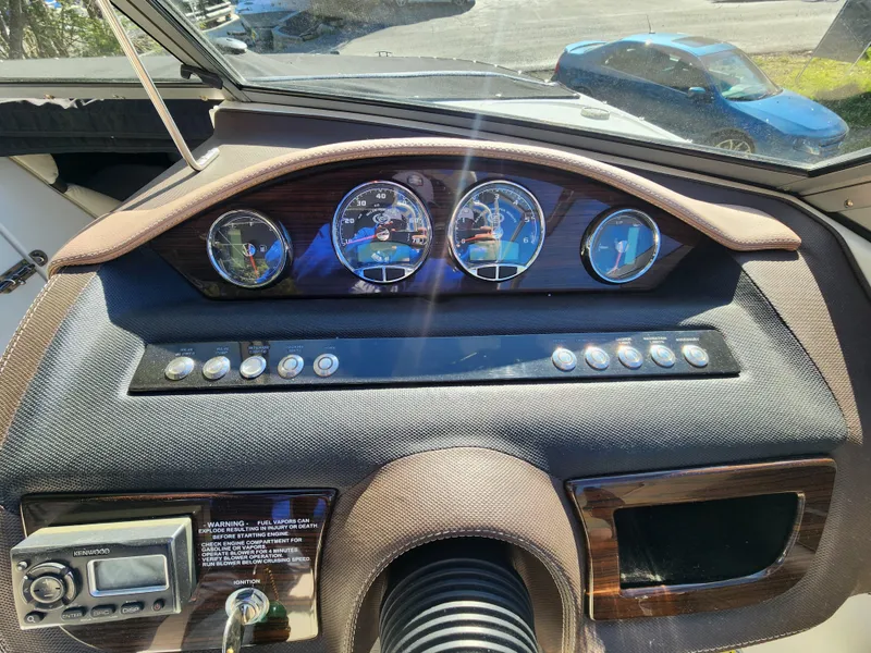 Slide: The Image of 2011 Cobalt A25 boat dashboard with gauges and controls. - 15