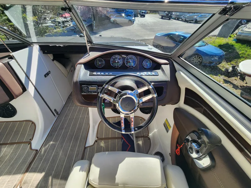 Slide: The Image of 2011 Cobalt A25 boat interior with steering wheel and dashboard. - 16