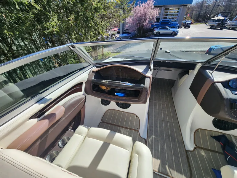 Slide: The Image of Interior of a 2011 Cobalt A25 boat with beige and brown seating. - 17