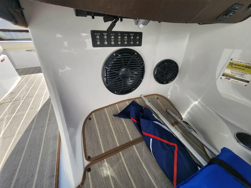 Slide: The Image of 2011 Cobalt A25 boat interior with speakers and storage area. - 18