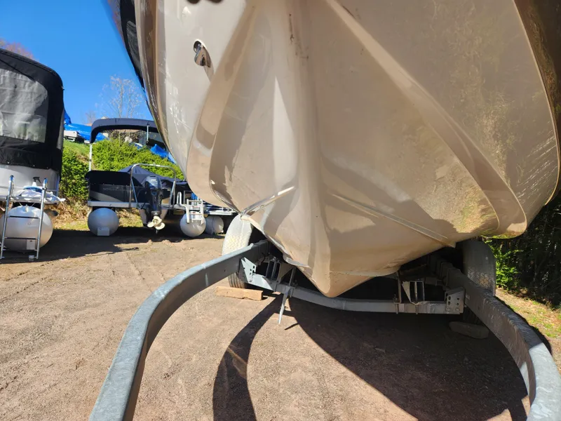 Slide: The Image of 2011 Cobalt A25 boat on a trailer, parked outdoors. - 2