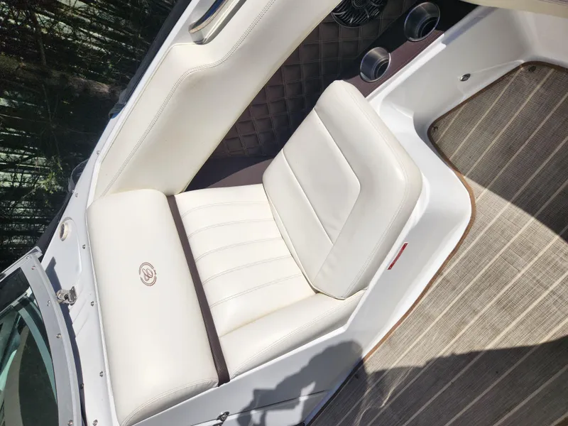Slide: The Image of 2011 Cobalt A25 boat with white leather seating and wood flooring. - 24