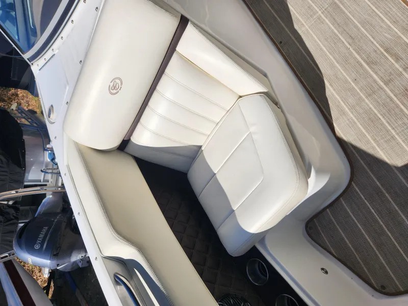 Slide: The Image of 2011 Cobalt A25 boat with white leather seating and Yamaha outboard motor. - 25