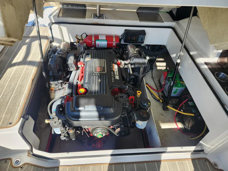 Slide: The Image of 2011 Cobalt A25 boat engine compartment with MerCruiser engine and fire extinguisher. - 6