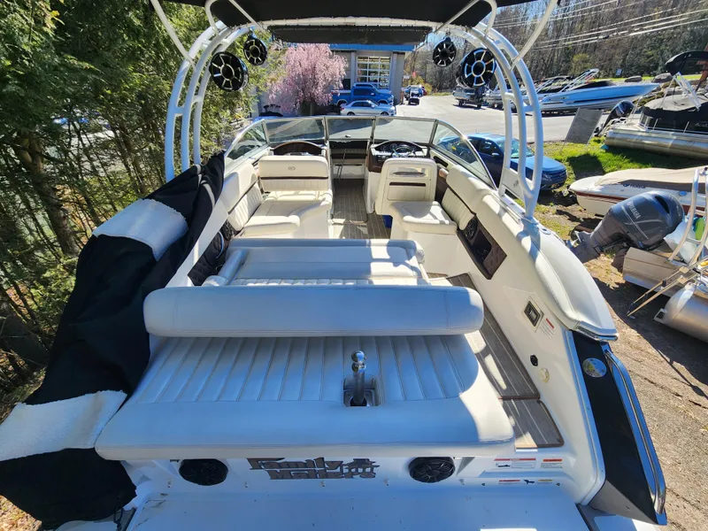 Slide: The Image of 2011 Cobalt A25 boat interior with white seating and modern dashboard. - 8