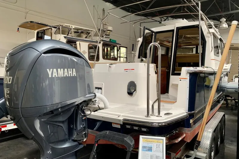 Slide: The Image of 2022 Ranger Tugs R-27 with Yamaha outboard motor in showroom. - 3