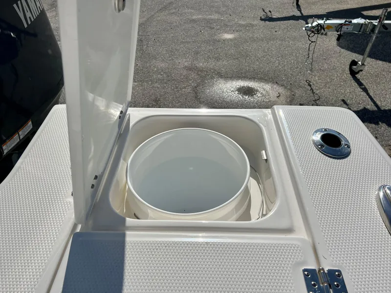 Slide: The Image of Livewell compartment on a 2024 Robalo 246 Cayman boat with Yamaha engine in the background. - 13