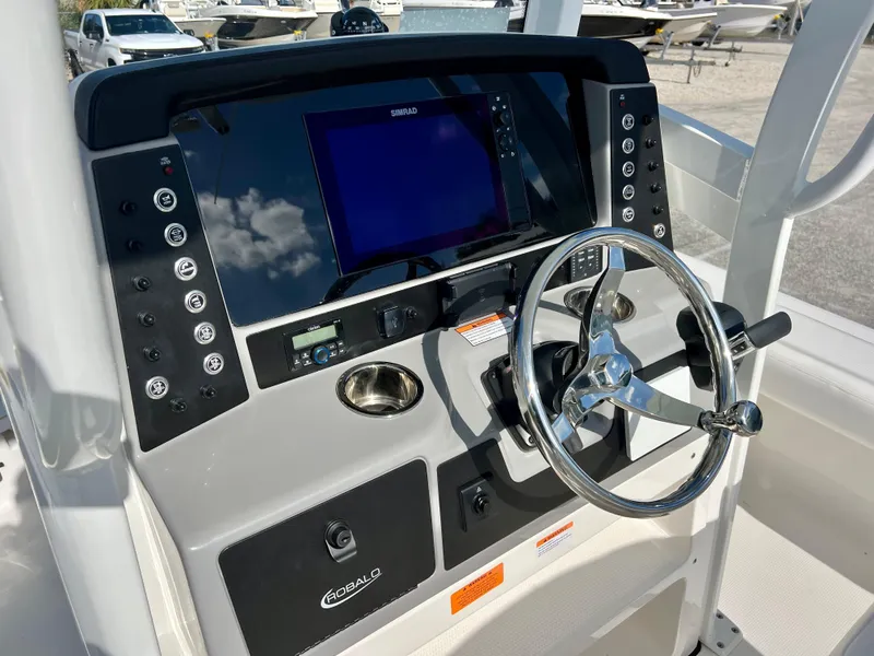 Slide: The Image of 2024 Robalo 246 Cayman boat console with steering wheel and navigation system. - 22