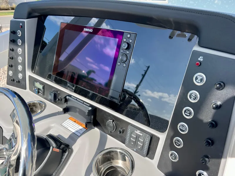 Slide: The Image of Control panel of 2024 Robalo 246 Cayman boat with Simrad display. - 23
