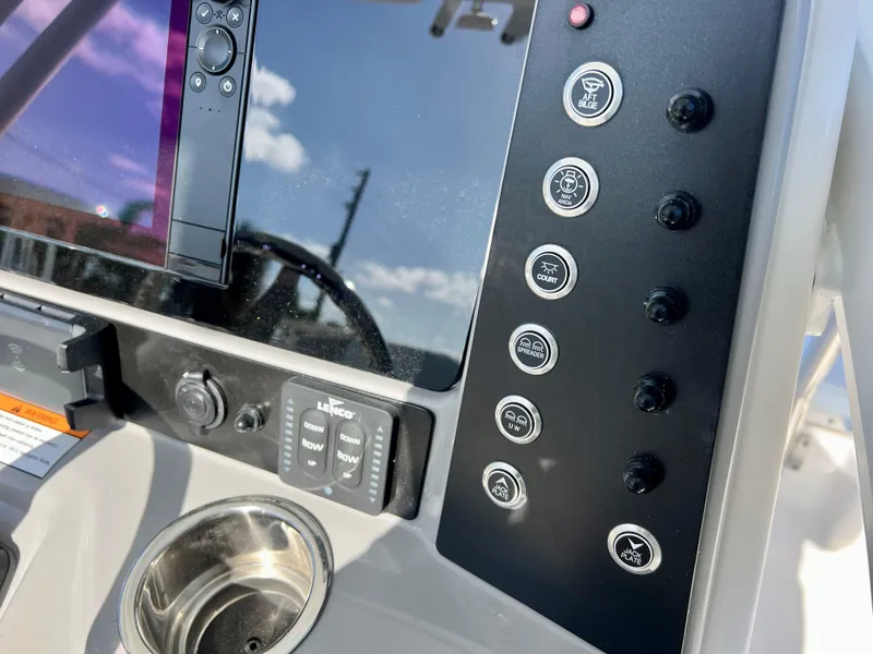 Slide: The Image of Close-up of the 2024 Robalo 246 Cayman boat control panel and switches. - 24