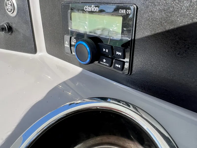 Slide: The Image of Clarion CMR-20 stereo system on 2024 Robalo 246 Cayman boat dashboard. - 26