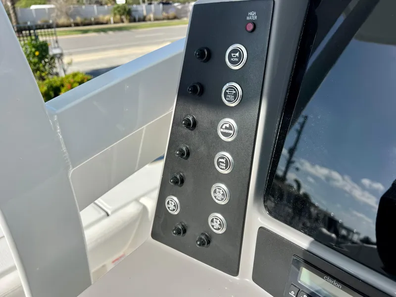 Slide: The Image of Control panel of the 2024 Robalo 246 Cayman boat with various function buttons. - 28