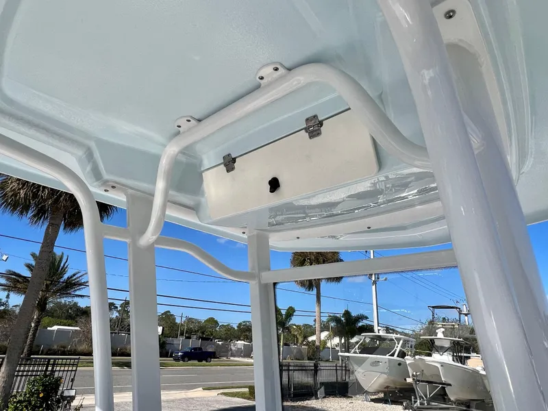 Slide: The Image of 2024 Robalo 246 Cayman T-top frame and storage compartment. - 30