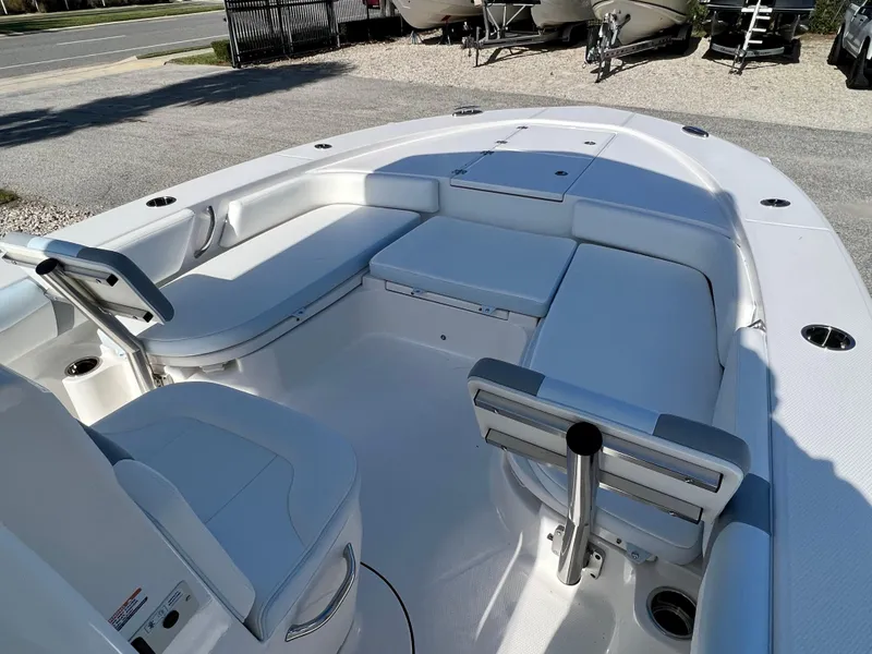 Slide: The Image of 2024 Robalo 246 Cayman boat interior with white seating and storage compartments. - 31