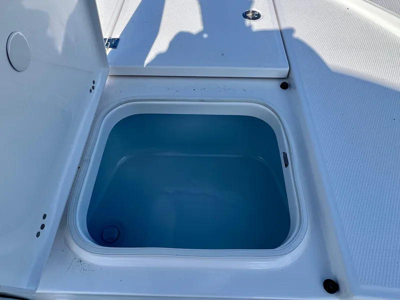 Slide: The Image of 2024 Robalo 246 Cayman boat storage compartment with open lid. - 32