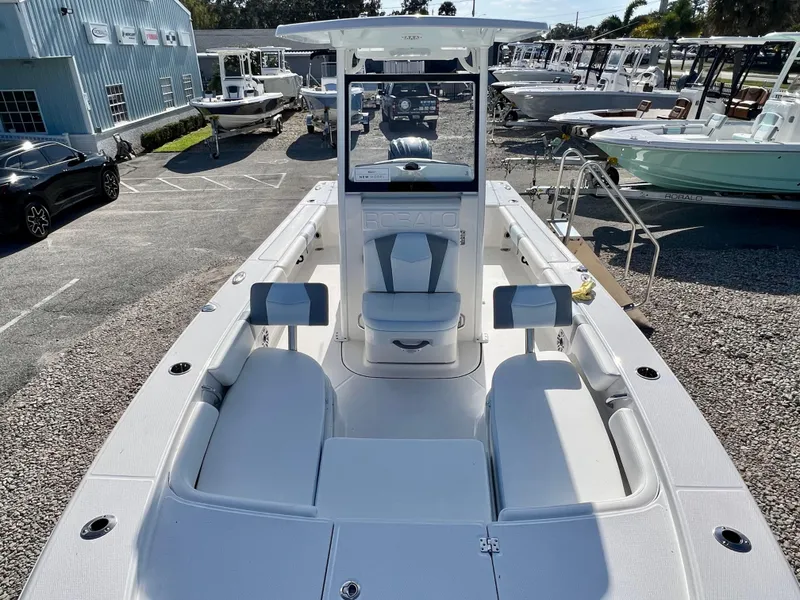 Slide: The Image of 2024 Robalo 246 Cayman boat on display at a dealership. - 33