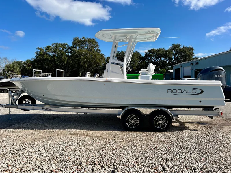 Slide: The Image of 2024 Robalo 246 Cayman boat on a trailer, side view, outdoors. - 4