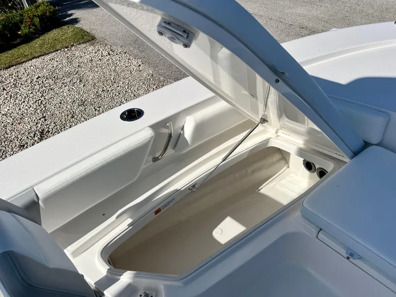 Slide: The Image of 2024 Robalo 246 Cayman boat storage compartment with open hatch. - 40