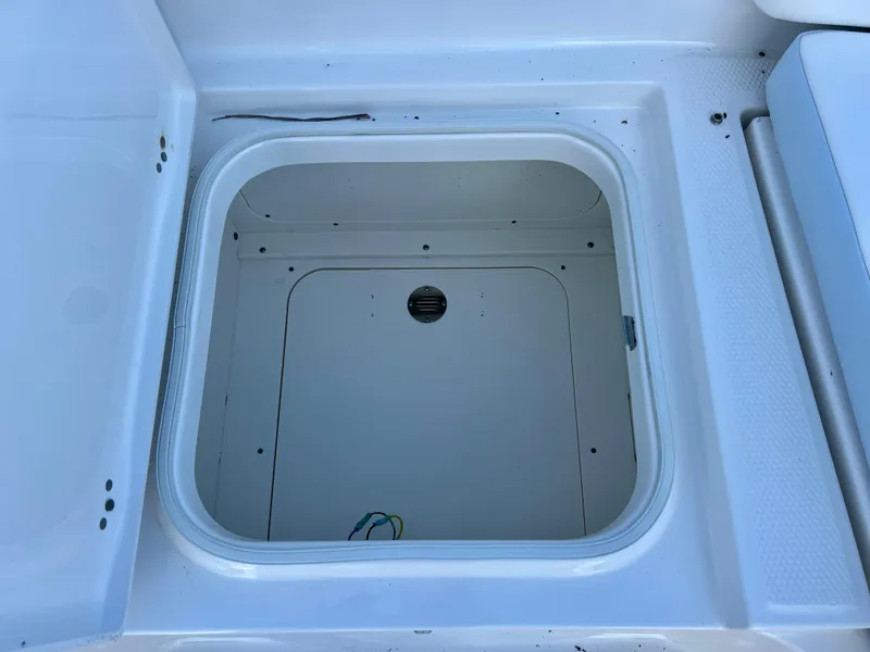 Slide: The Image of Open storage compartment on a 2024 Robalo 246 Cayman boat. - 41