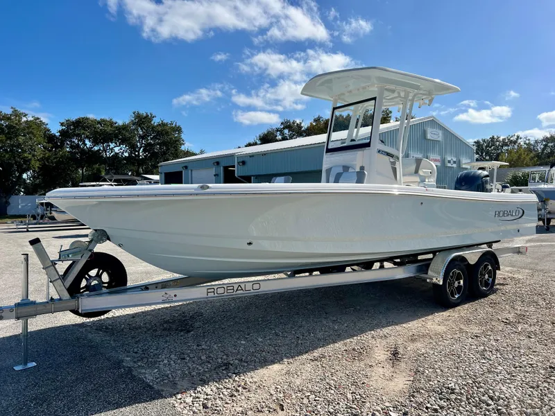 Slide: The Image of 2024 Robalo 246 Cayman boat on a trailer, parked outdoors. - 5