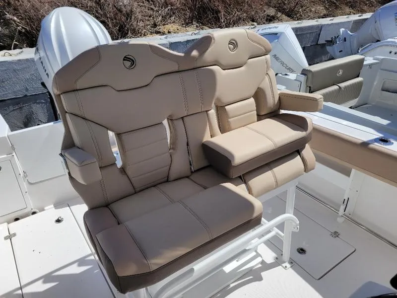 Slide: The Image of 2024 Edgewater 245 CC boat with beige cushioned seating. - 11