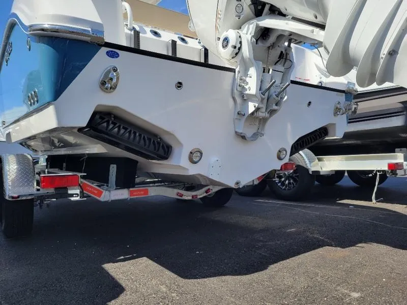 Slide: The Image of 2024 Edgewater 245 CC boat on trailer, rear view showing hull and propeller. - 4