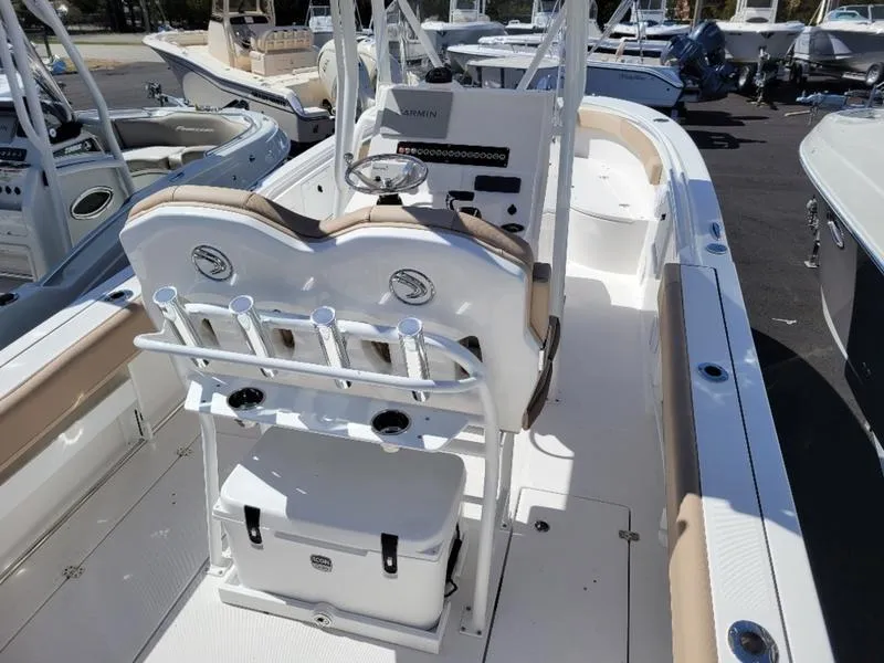 Slide: The Image of 2024 Edgewater 245 CC boat interior with seating and steering console. - 8