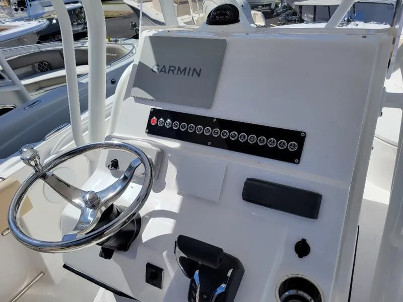 Slide: The Image of 2024 Edgewater 245 CC boat dashboard with Garmin navigation system. - 9
