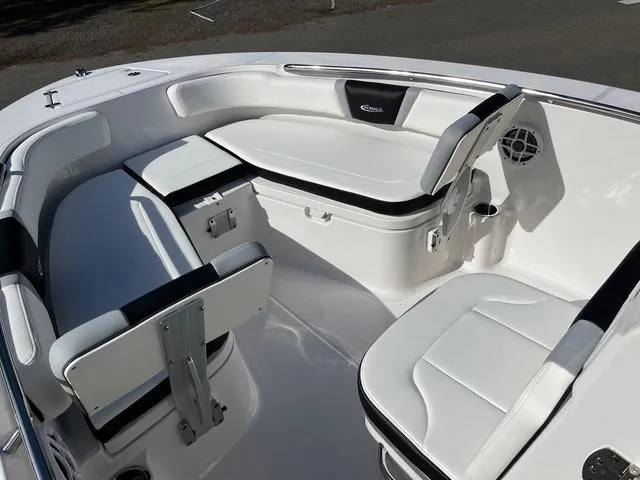 Slide: The Image of 2024 Robalo R200 boat interior with white cushioned seating and storage compartments. - 6