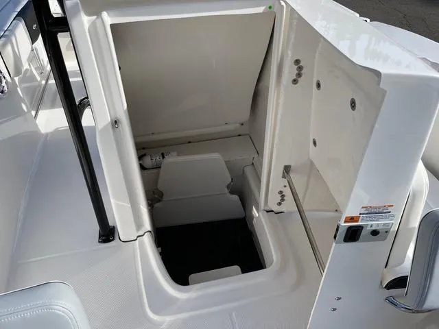 Slide: The Image of 2024 Robalo R200 boat storage compartment with open hatch. - 8