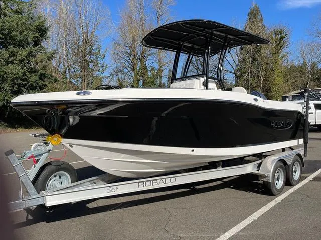 Slide: The Image of 2024 Robalo R200 boat on a trailer in a parking lot. - 9